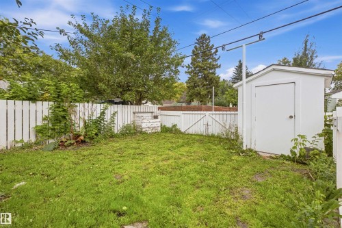 Fenced backyard featuring a storage shed - 13024 Sherbrooke Avenue Nw, Edmonton, AB 