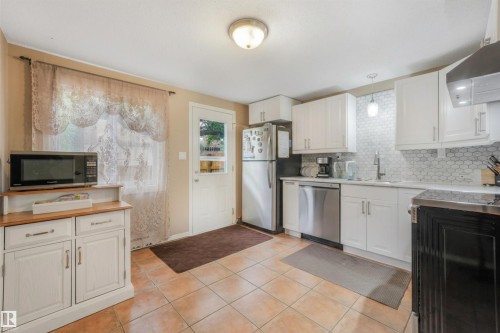 Large Kitchen Space featuring modern white and grey backsplash, stainless steel appliances, butcher block moveable island, and BRAND NEW COUNTERTOPS! - 267 Ridgewood Terrace, St. Albert, AB - Indoor Photo Showing Kitchen