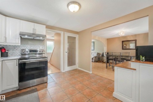 Large Kitchen Space featuring modern white and grey backsplash, stainless steel appliances, butcher block moveable island, and BRAND NEW COUNTERTOPS! - 267 Ridgewood Terrace, St. Albert, AB - Indoor Photo Showing Kitchen