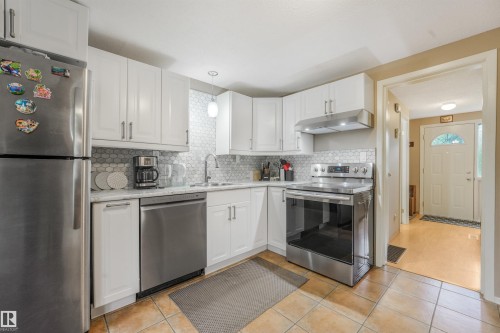 Large Kitchen Space featuring modern white and grey backsplash, stainless steel appliances, butcher block moveable island, and BRAND NEW COUNTERTOPS! - 267 Ridgewood Terrace, St. Albert, AB - Indoor Photo Showing Kitchen With Stainless Steel Kitchen