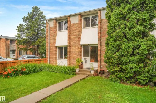 Front of home featuring vinyl siding and brick exterior, mature trees, and walking path leading to home. - 267 Ridgewood Terrace, St. Albert, AB - Outdoor