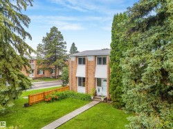 Front of home featuring vinyl siding and brick exterior, mature trees, and walking path leading to home. - 