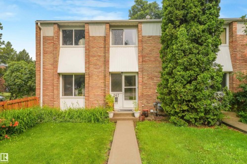 Front of home featuring vinyl siding and brick exterior, mature trees, and walking path leading to home. - 267 Ridgewood Terrace, St. Albert, AB - Outdoor