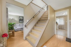Front entry way inside the home. When you walk in to the left there is mud room space for shoes and coat. Living room space to the right features open concept living area with dining room and kitchen. - 