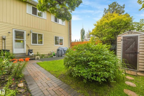 Private backyard space featuring a fully fenced area, storage shed, stone walking path, and beautiful landscaping. - 267 Ridgewood Terrace, St. Albert, AB - Outdoor