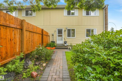 Private backyard space featuring a fully fenced area, storage shed, stone walking path, and beautiful landscaping. - 267 Ridgewood Terrace, St. Albert, AB - Outdoor