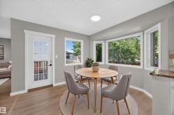 Wood-finish flooring, white trim, recessed lighting, and a bay window - 