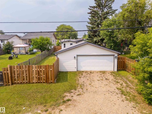 Detached garage with white siding and a panel garage door - 5103 50 Street, Cold Lake, AB - Outdoor
