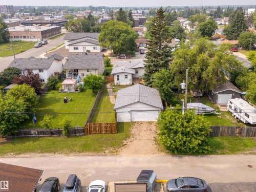 Two-car detached garage with asphalt shingles and a paved driveway - 5103 50 Street, Cold Lake, AB - Outdoor With View