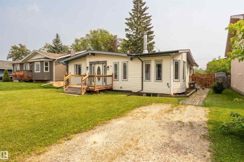 Ranch-style exterior with light-colored siding and a contrasting dark trim - 5103 50 Street, Cold Lake, AB - Outdoor With Deck Patio Veranda