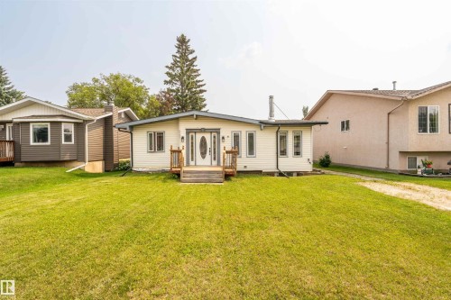 Ranch-style residence featuring light-colored siding and a gabled roofline - 5103 50 Street, Cold Lake, AB - Outdoor