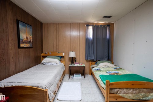 Room featuring paneling on two walls, a window with drapery, and tile flooring - 10428 68 Avenue Nw, Edmonton, AB 