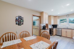 Kitchen with light wood cabinetry, recessed lighting, and stainless steel appliances - 