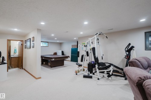 Recessed lighting, wood-finish trim, light-toned carpeting, and a built-in vanity with wood-finish cabinetry - 10924 35A Avenue Nw, Edmonton, AB 