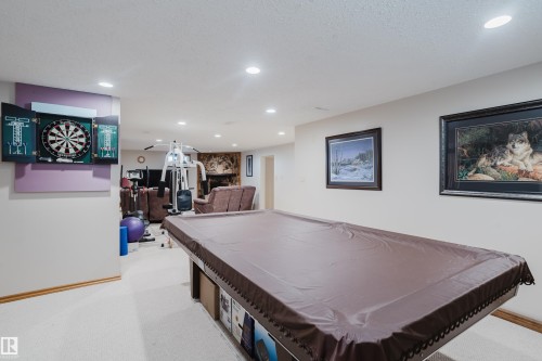 Recessed lighting illuminates the carpeted flooring and light-toned walls - 10924 35A Avenue Nw, Edmonton, AB 
