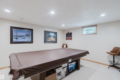 Recessed lighting, wood-trim window, and neutral wall tones - 10924 35A Avenue Nw, Edmonton, AB 