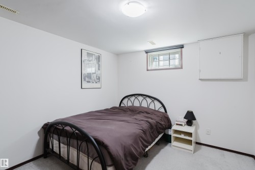 Recessed window with wood-finish trim, white painted walls, and light-colored carpeting - 10924 35A Avenue Nw, Edmonton, AB 