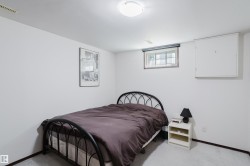 Recessed window with wood-finish trim, white painted walls, and light-colored carpeting - 