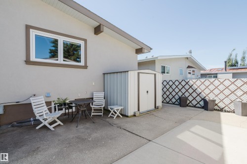 Poured concrete patio with a metal storage shed and a decorative lattice fence - 10924 35A Avenue Nw, Edmonton, AB 