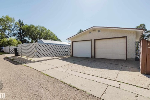 Two-car detached garage with stucco exterior and panel garage doors - 10924 35A Avenue Nw, Edmonton, AB 