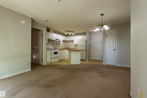 Open-concept living area with integrated kitchen - #316 11325 83 St Nw, Edmonton, AB 