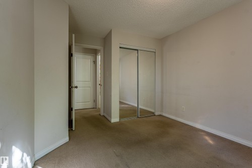 Neutral-toned walls complement the carpeted flooring - #316 11325 83 St Nw, Edmonton, AB 