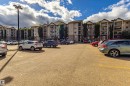 Multistory residential building with multiple balconies, a covered entrance, and an adjacent parking area - #316 11325 83 St Nw, Edmonton, AB 
