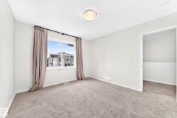 Neutral wall paint, textured ceiling, carpeted flooring, and an open doorway - 