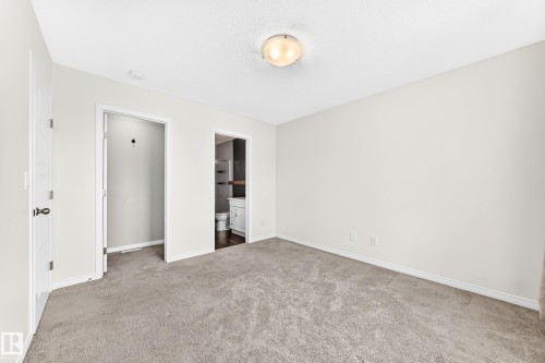 Plush carpet flooring, a flush-mount ceiling light fixture, and white painted walls - 20008 19 Avenue Nw, Edmonton, AB 