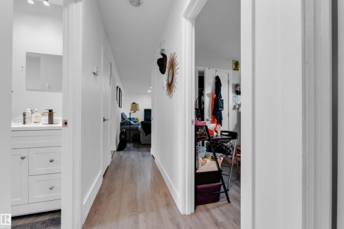 Hallway featuring wood-finish flooring and white walls - 14216 58 Street Nw, Edmonton, AB 