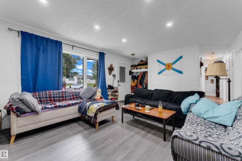 Recessed ceiling lighting, wood-finish flooring, and large windows - 14216 58 Street Nw, Edmonton, AB 