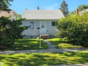 Siding exterior with a pitched shingle roof, front entry steps, and mature landscaping - 10438 147 Street Nw, Edmonton, AB 