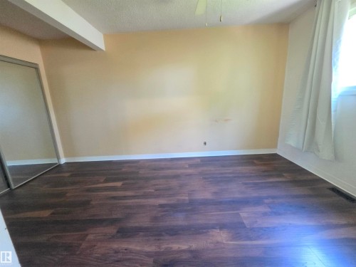 Wood-finish flooring with white trim - 10438 147 Street Nw, Edmonton, AB 