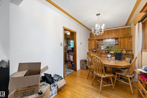 Hardwood flooring, crystal chandelier, built-in cabinetry, wood-paneled walls, and wood-trim ceiling - 10621 60A Avenue Nw, Edmonton, AB 