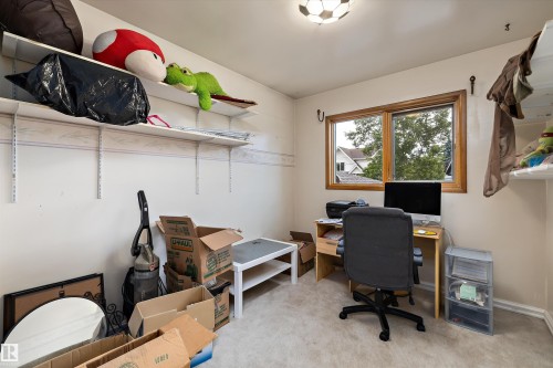 Double-pane window with wood trim, ceiling-mounted light fixture, and wall-mounted shelving - 10621 60A Avenue Nw, Edmonton, AB 