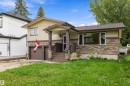 Stucco and stone facade with a covered entry, concrete stairs, and an attached two-car garage - 10621 60A Avenue Nw, Edmonton, AB 