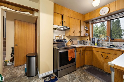 Wood-finish cabinetry with coordinating wall paneling - 10621 60A Avenue Nw, Edmonton, AB 