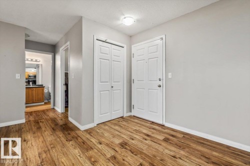 Wood-finish flooring, white trim, light gray wall paint, and overhead lighting - #110 4309 33 St, Stony Plain, AB 
