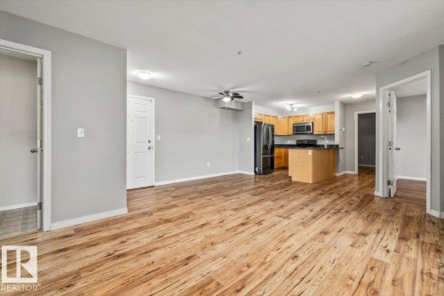 Spacious living area featuring wood-finish flooring - #110 4309 33 St, Stony Plain, AB 