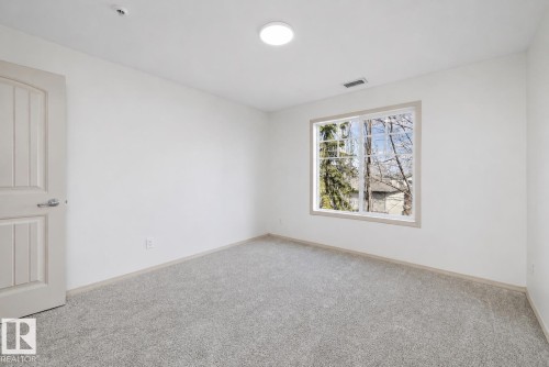 Bright room featuring neutral-toned carpet flooring and clean white walls - #353 2096 Blackmud Creek Dr Sw, Edmonton, AB - Indoor Photo Showing Other Room