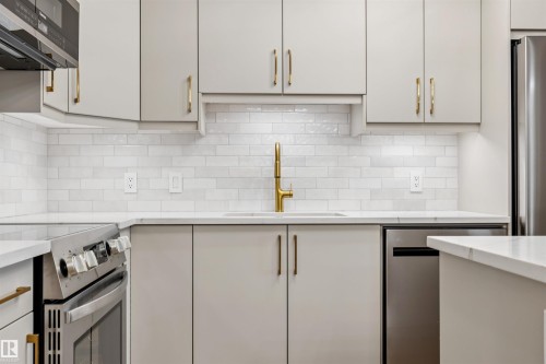 Contemporary kitchen featuring light gray cabinetry, white subway tile backsplash, and white countertops - #353 2096 Blackmud Creek Dr Sw, Edmonton, AB - Indoor Photo Showing Kitchen With Upgraded Kitchen