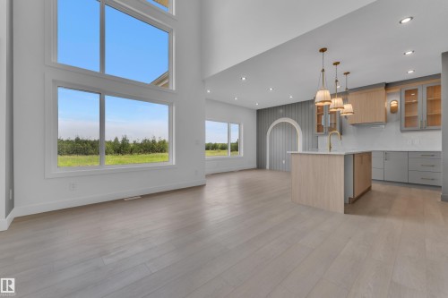 Expansive open-concept living area with soaring ceilings and large windows - 1129 Starling Drive Nw, Edmonton, AB 