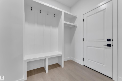 Built-in hall tree with a bench, storage cubbies, and garment hooks - 1129 Starling Drive Nw, Edmonton, AB 