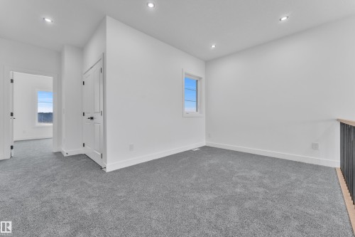 Recessed lighting illuminates the carpeted flooring and white walls - 1129 Starling Drive Nw, Edmonton, AB 