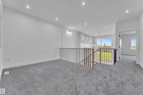 Open landing featuring recessed lighting, a modern horizontal baluster railing, and plush grey carpeting - 1129 Starling Drive Nw, Edmonton, AB 