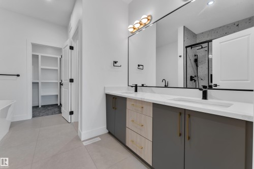 Dual vanity with white countertops, matte black faucets, and under-mount sinks - 1129 Starling Drive Nw, Edmonton, AB 