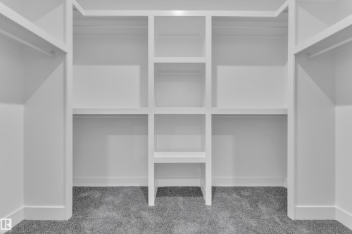 Built-in closet organization system with multiple shelving units and hanging rods - 1129 Starling Drive Nw, Edmonton, AB 