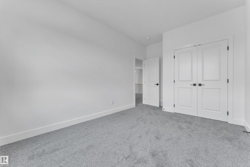 Light grey carpeting complemented by white baseboards and walls - 1129 Starling Drive Nw, Edmonton, AB 