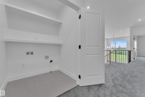 Laundry area with tile flooring and built-in shelving - 1129 Starling Drive Nw, Edmonton, AB 