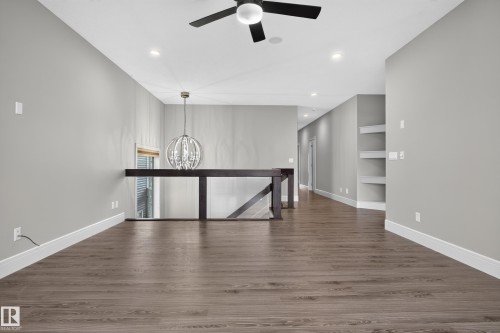 Wood-finish flooring throughout, recessed lighting, and built-in shelving - 2219 22 Street Nw, Edmonton, AB 